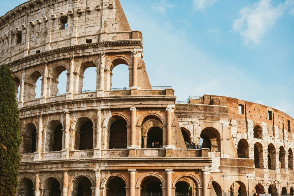 A stunning daytime shot of the famous Colosseum in Rome, showcasing its ancient architectural grandeur.